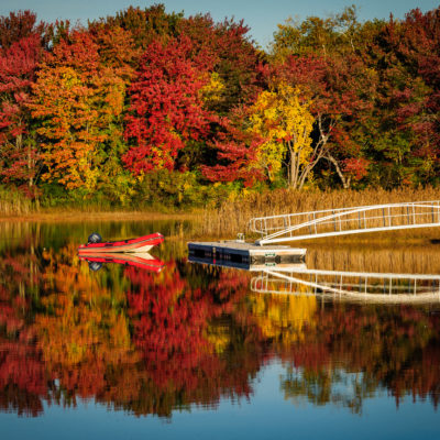 Dinghy on lake with fall foliage near Kennebunkport, Maine