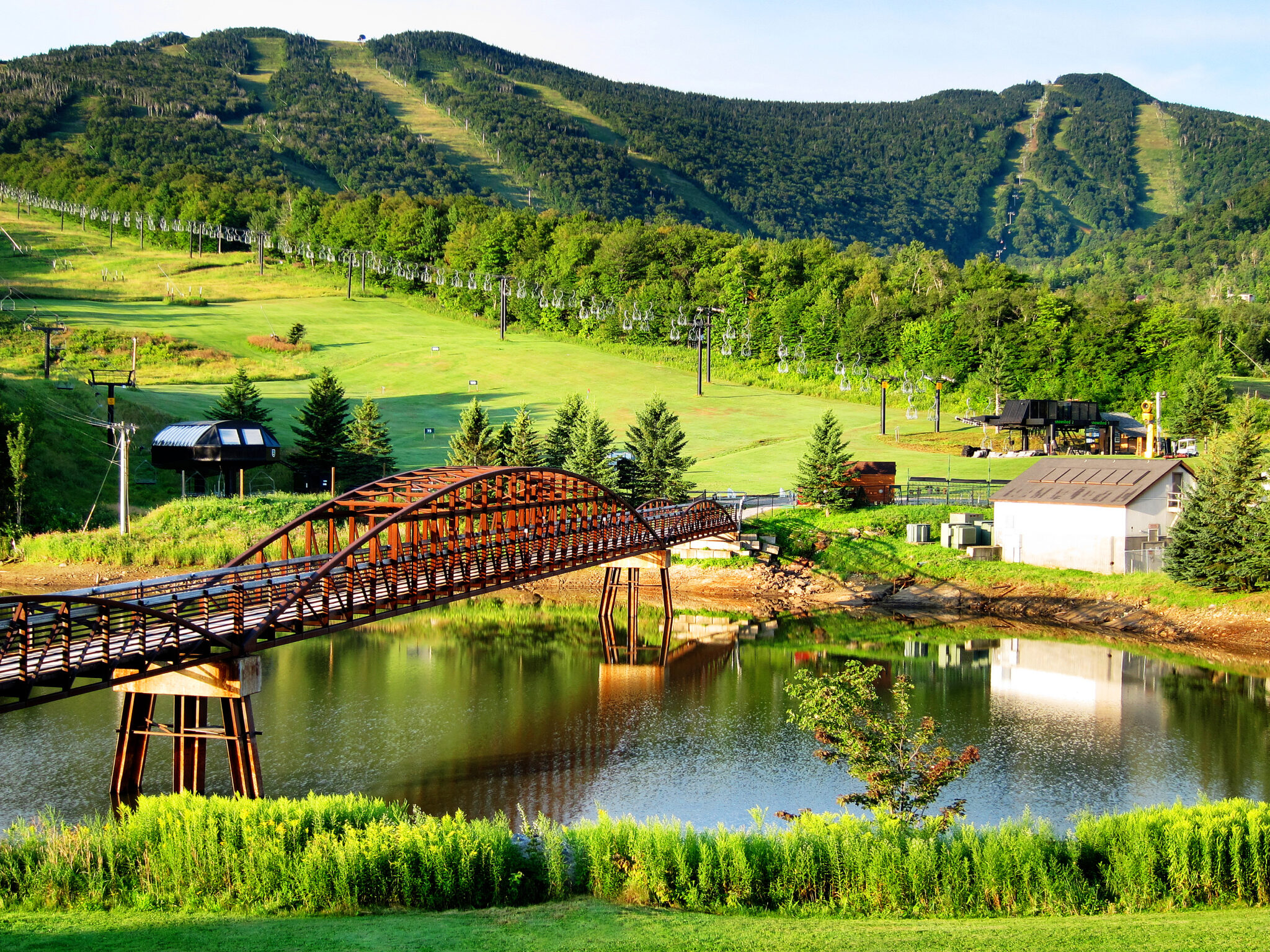 Vermont mountain resort with a footbridge over the water