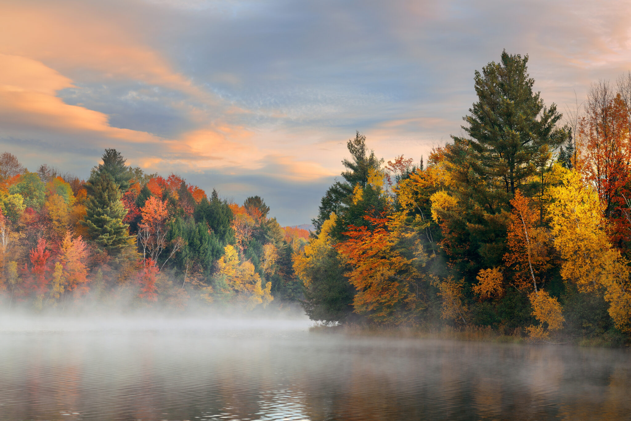 Misty Vermont lake framed by brilliant fall foliage