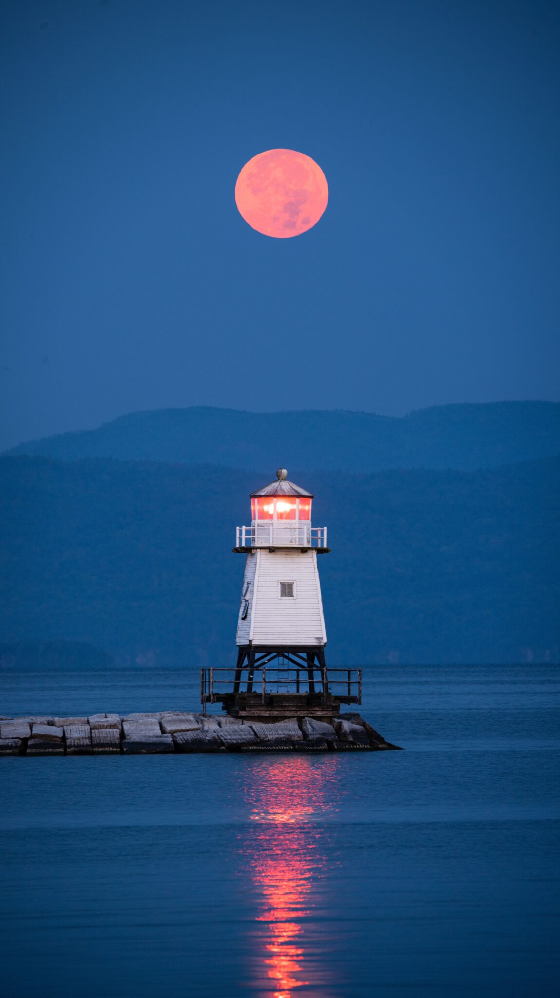 Lighthouse on Lake Champlain beneath a full moon